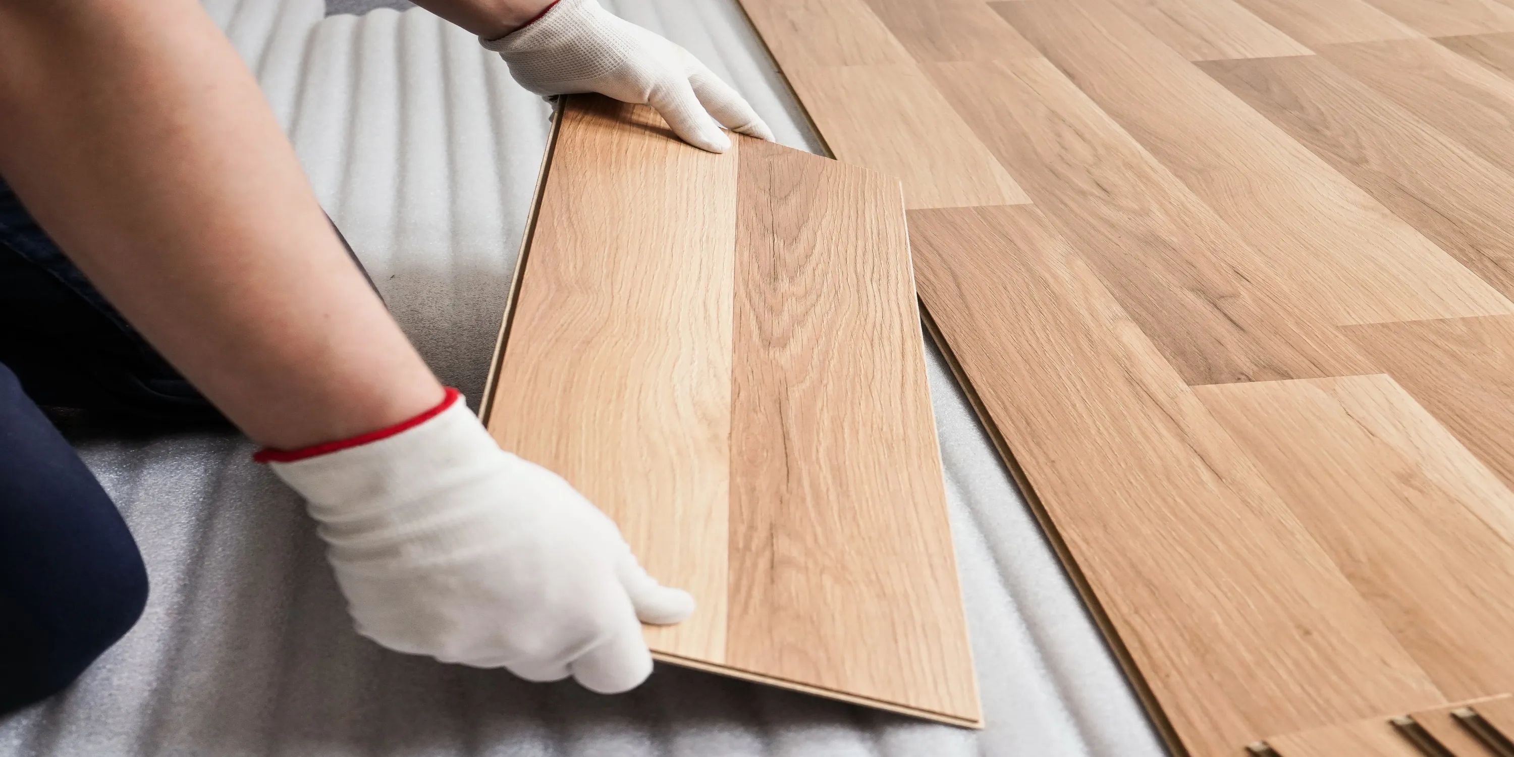 remodeling project in which worker is placing new floor